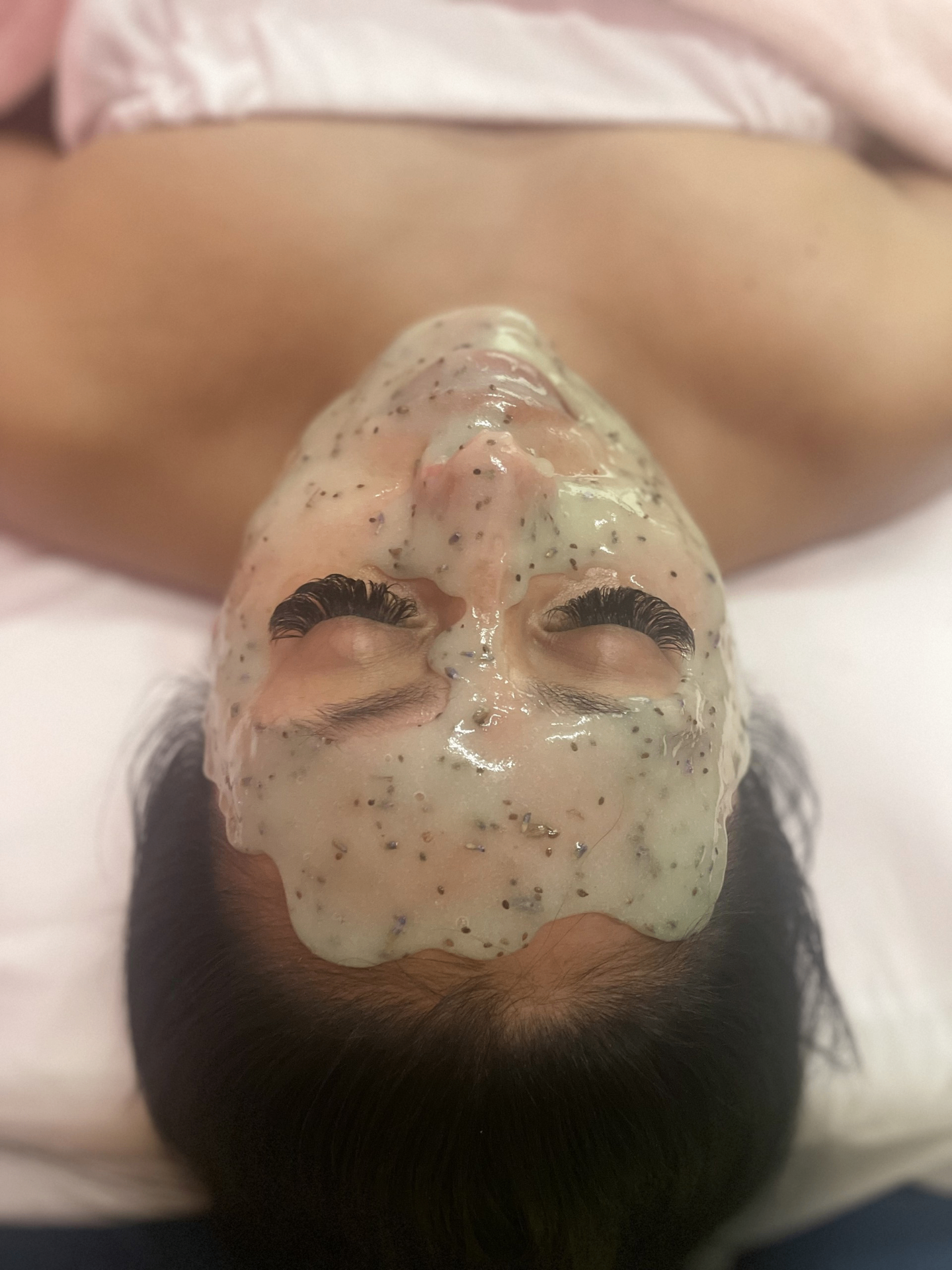 Client during a detoxifying mask treatment